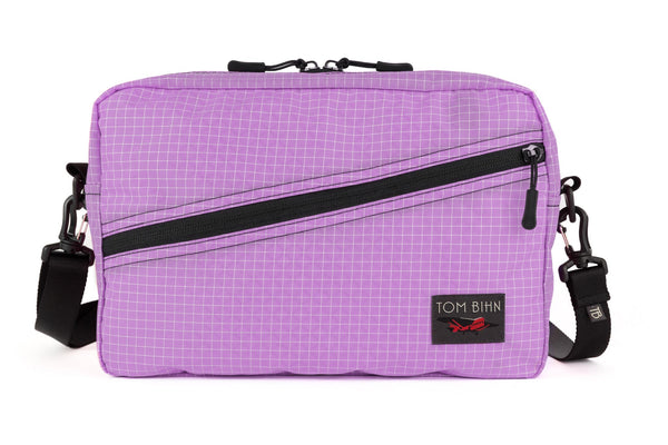 A Packing Cube Shoulder Bag in Wisteria (pale purple with white grid) 200 Halcyon with a 1-inch shoulder strap attached